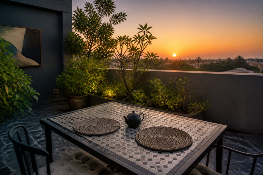 A spacious terrace with a dining table, flowers, and outdoor decor.
