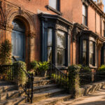 Victorian terrace houses lined up, displaying their distinctive architectural features.